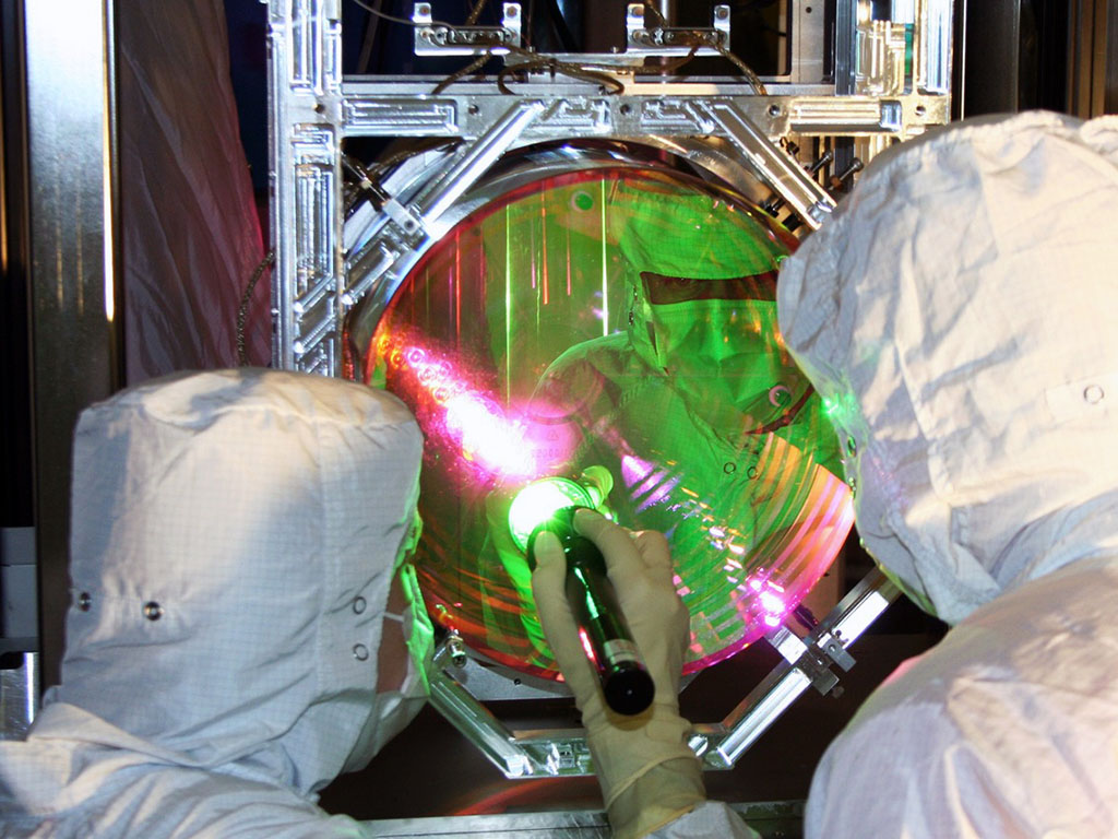 MIT scientists have cooled a 10-kilogram object to a near standstill, using LIGO’s precise measurements of its 40-kilogram mirrors. Shown here are LIGO optics technicians examining one of LIGO’s mirrors.