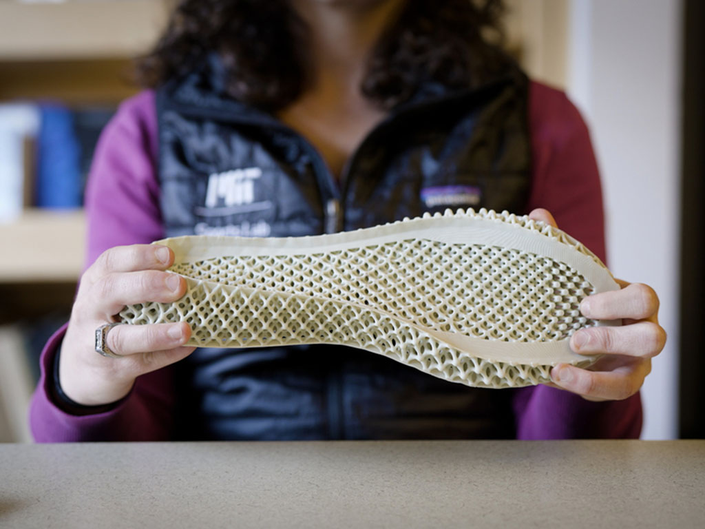 Researcher Sarah Fay holding a 3D printed shoe sole