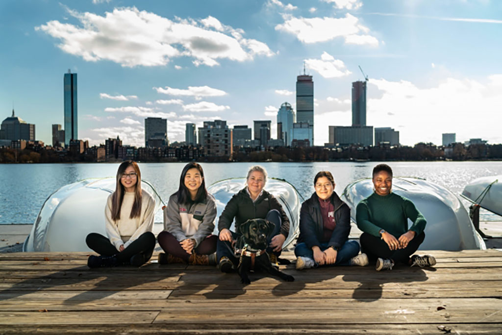 the group od students sitting on a dock