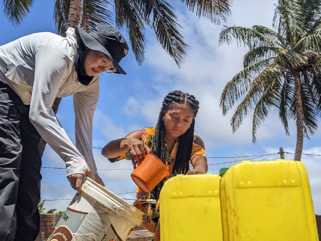 Two individuals working on a  desalination system