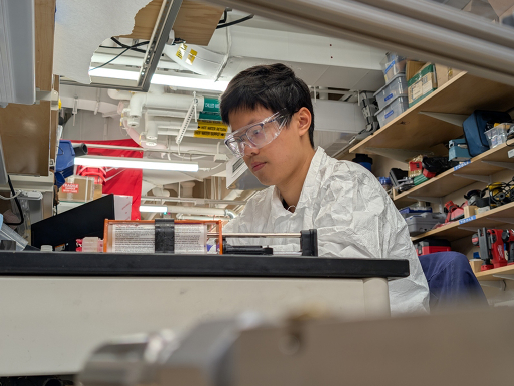 Lead author ZhiYi Liang assembles prototypes in the lab.